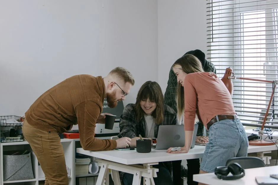 A stylish workspace featuring a laptop and monitors displaying design software.